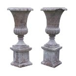 A pair of marble campana urns,each raised on a socle and a plinth, with losses, 147cm high (2)