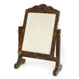 An tortoiseshell and ivory dressing table mirror, early 20th century, the shaped crest over a