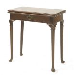 A George III mahogany fold-over card table, with a baized top over carved knees on a slender