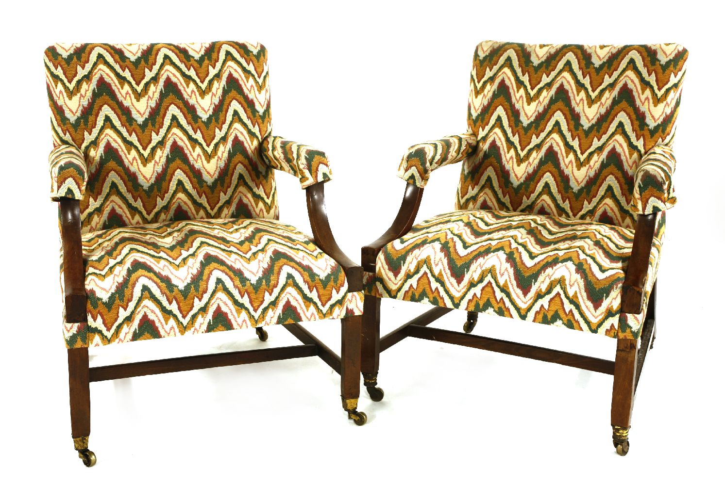 Two similar George III mahogany Gainsborough chairs,each with zigzag upholstery, raised on