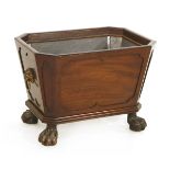 A George III mahogany wine cooler,with a lined interior and panelled sides and corners on boldly