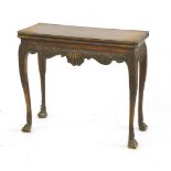 An Irish mahogany fold-over card table, profusely carved,81cm wide40cm deep73cm high Provenance: The