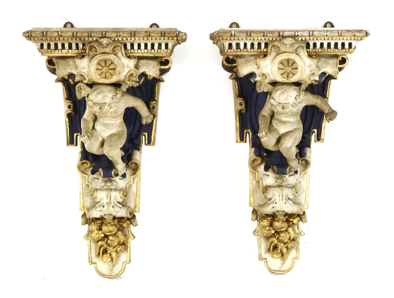 Two painted and carved wall brackets,19th century, each modelled as a putto and polychrome painted