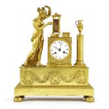 A large gilt metal mantel clock,late 19th century, with a white enamel dial flanked by a figural