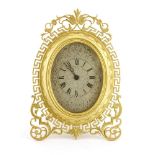 A gilt bronze strut clock,19th century, in the manner of Thomas Cole, the oval dial engraved with