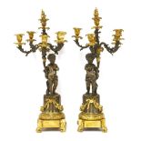 A pair of bronze and ormolu five-light candelabra,the stylised foliate arms supported by putti