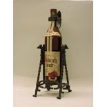 Uralt Five Star Brandy, Asbach, one 105fl.oz. bottle (on wrought iron decorative stand)