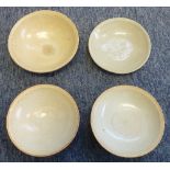 Two Song Dynasty style Dishes together with two other similarly sized Bowls on short circular feet,