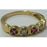 A ladies 18-carat yellow gold Dress Ring set with two diamonds and three rubies;
