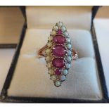 A ladies marquise shape Ring set with five graduated rubies and surrounded by small opals