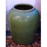 A large Chinese ovoid pottery Jar with overall green glaze, approx.