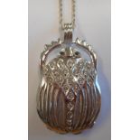 A heavy 18-carat white gold Scarab Pendant set with diamonds and sapphire eyes