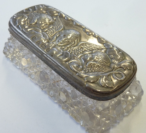 A cut glass Dressing Table Requisite Jar having a hallmarked silver lid decorated repoussé style