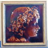 An interesting late-19th/early-20th century framed Hearthstone depicting a brown glazed profile of