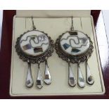 An unusual pair of silver, mother of pearl and stone inlaid,