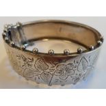 A silver Bangle decorated with floral and foliate engraving