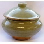 A Yuan style Pot and Cover of circular compressed form, Celadon glaze and unglazed circular foot,