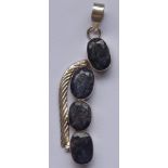 A modern designer silver Pendant set with four hand-cut oval low-grade sapphires,