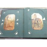 An early 20th century Postcard Album containing an interesting variety of mostly colour (some