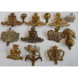 Five good artillery cap badges and seven local cavalry and infantry cap badges: three Royal