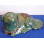 A green glazed Chinese ceramic Karashishi in recumbent pose,