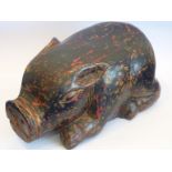 A carved wooden Chinese Pig with lacquer and gilt splashes etc., (probably mid 20th Century), 22.