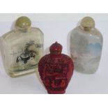 Three Chinese snuff bottles: an interior-painted glass bottle decorated with a dog and cat;