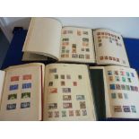 Six stamp albums containing a variety of mostly late-19th / early-20th century woldwide stamps
