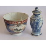 A small circa 1900 Chinese porcelain vase and cover painted in underglaze blue with a figure,