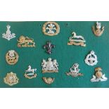 Fourteen Yorkshire and Lancastrian infantry cap badges mounted on a display board: Alexandra,