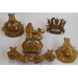 Four naval badges: a Howe and two Royal Marines Commando Corps cap badges;