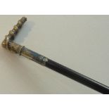 A late 19th century ebonised Walking Cane with a silver-plate mounted handle depicting a writhen