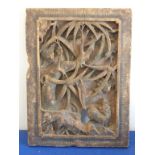 An early Chinese softwood Panel carved with animals amongst trees and foliage etc.