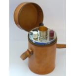 A modern tan leather three-sectional Flask Case, with four gilded 'tots' centring,