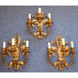 A set of three gilt-metal mounted three-light wall appliques in the Classical style,