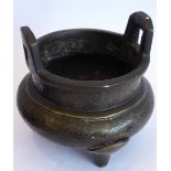 A Chinese patinated bronze tripod censer; two lug handles,