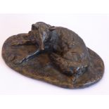 A heavy 20th century patinated bronze sculpture of a recumbent fox;