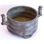 A heavy circular Chinese patinated bronze tripod censer;