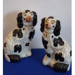 A pair of 19th century Staffordshire flat back black-and-white Spaniels, 25.