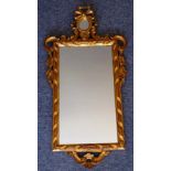 An 18th Century (later) style carved giltwood framed wall hanging looking glass,