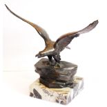 A French Art Deco period sculpture of an open-winged eagle upon rocks,