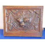 A nicely carved piece of 19th century oak panelling decorated in relief with bows, swags, fruit etc.
