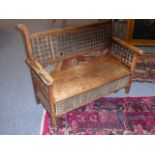 A late 19th century Arts and Crafts aesthetic-style two-seater walnut settle;