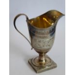 A neo-classical style, helmet-shaped, hallmarked silver cream jug; gilded interior,