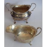 A hallmarked silver two-handled sugar together with a similar (unrelated) three-legged sauce boat;