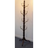 An early 19th century Regency period mahogany country house style hat-and-coat stand with four rows