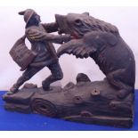 A Black Forest style wooden carving of a woodsman fighting a bear,