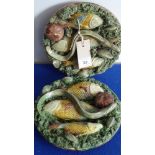 A pair of late 19th century Portuguese ceramic wall hanging reliefs in the style of Bernard Palissy;