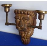 A carved and gilded wall bracket modelled as a lion's head (now fitted for electricity),