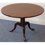 A Georgian circular mahogany birdcage mechanism table on tripod base with pointed pad feet,